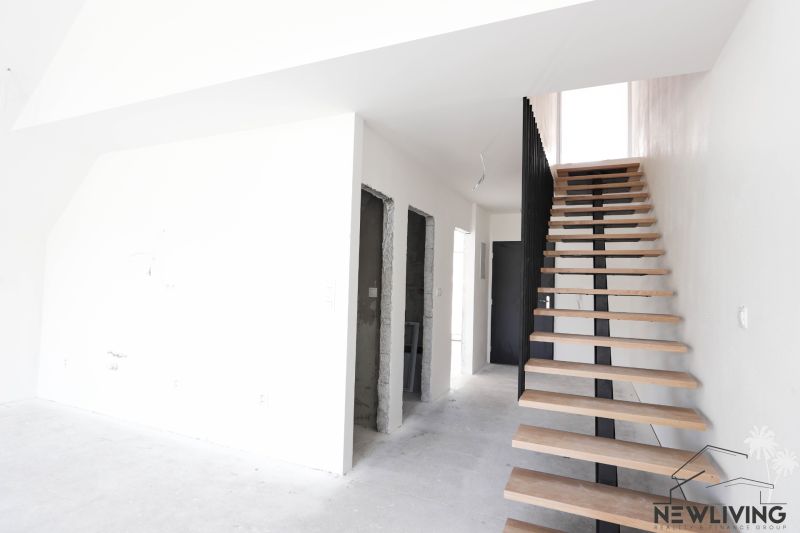 Staircase and entrances in a 4-room apartment with a wooden decor floor.