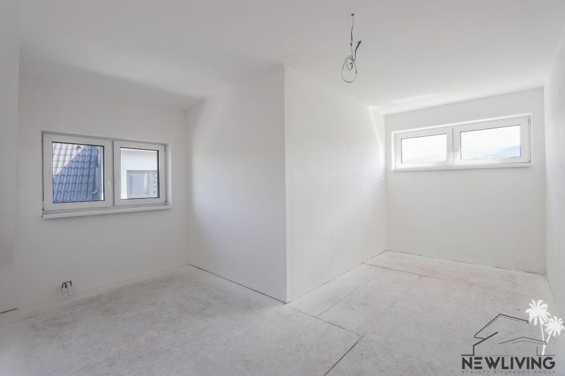 White room and two windows in a 4-room apartment, floor with wood decor.