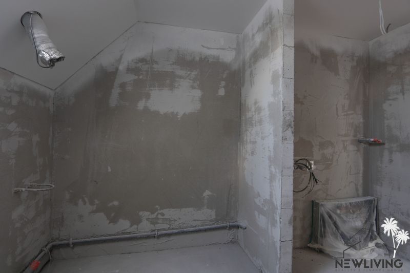 An unfurnished room in a 4-room apartment with rough plaster and preparation for installations.