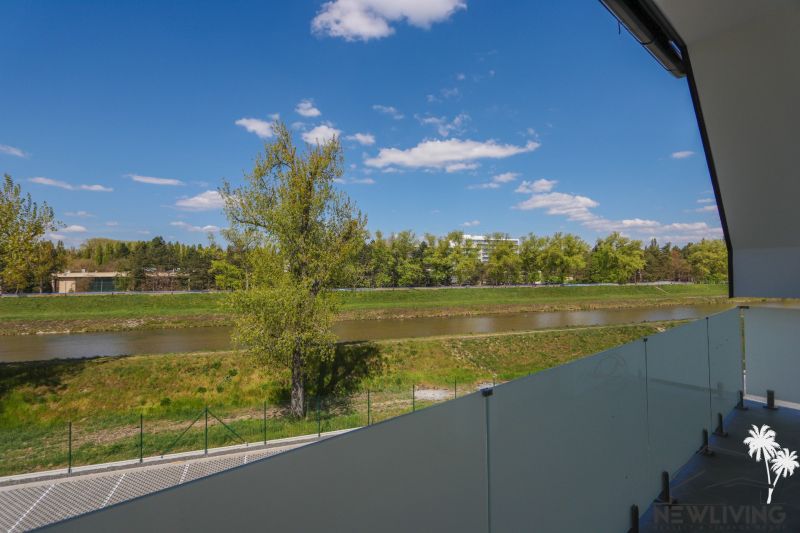 View from the balcony to greenery and the river on Moravanská Street in Banka.