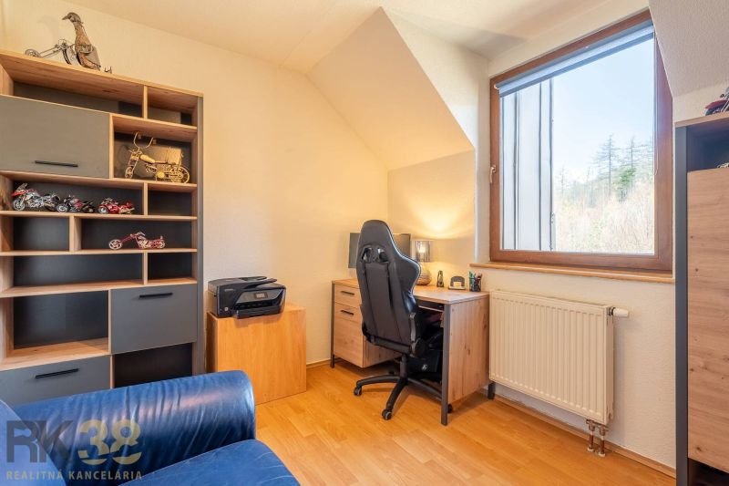 A workspace with a wooden floor decor in a 4-room apartment.
