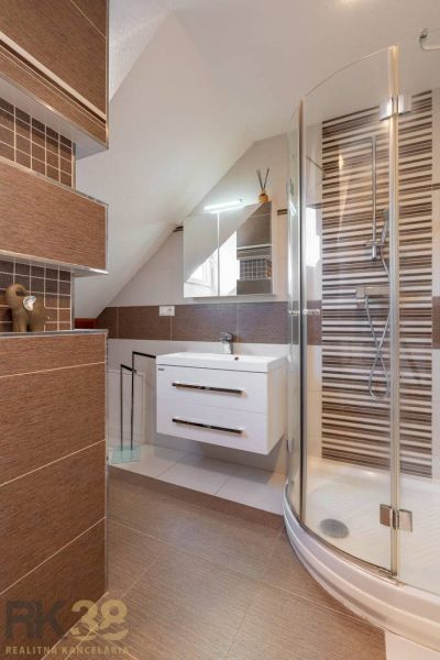 A bathroom in a 4-room apartment with elegant tiles and a shower corner.