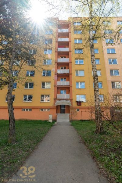 Apartment building on Partizánska Street in Poprad with a staircase and greenery in the surroundings.