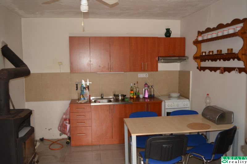 A kitchen in a family house with a dining table and wooden furniture.