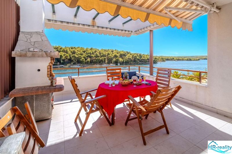 Terrace of a recreational apartment in Brač with a sea view and outdoor seating.
