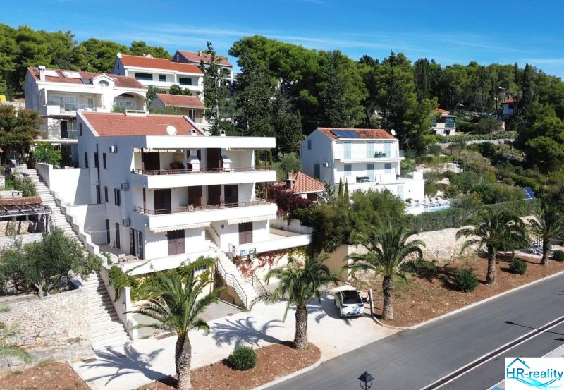 A holiday apartment in Brač with a sea view and surrounding greenery.