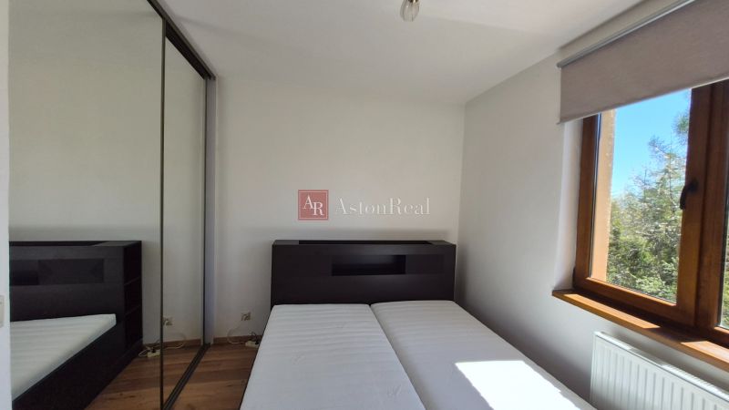 Bedroom in a holiday apartment with a wooden decor floor and a wardrobe.