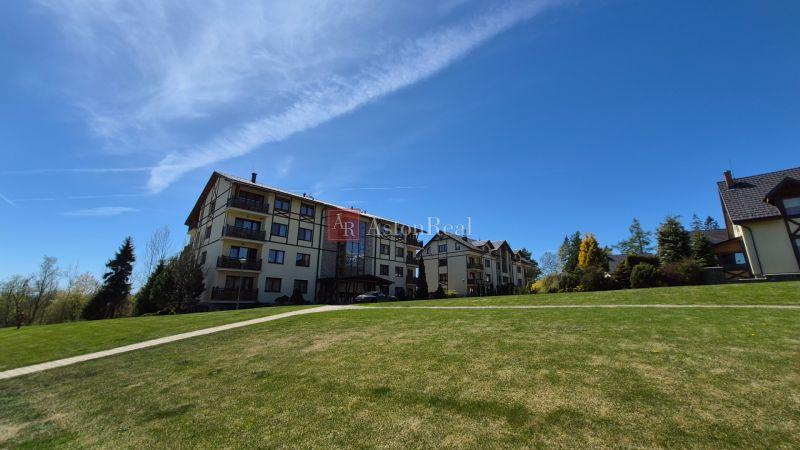 A recreational apartment in Stará Lesná in the High Tatras, surrounded by lawn and trees.