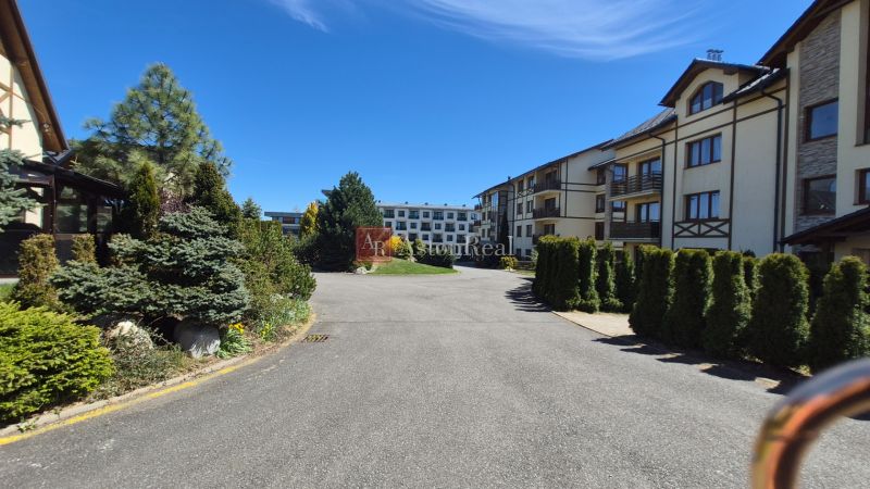 The exterior of a holiday apartment in Stará Lesná near the High Tatras with landscaped greenery.