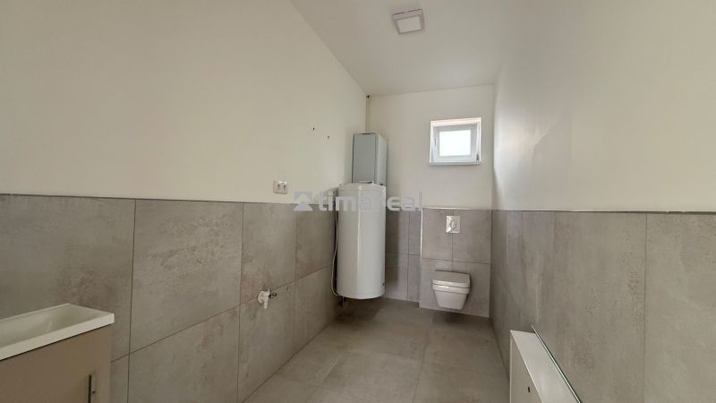 Bathroom in a family house with a toilet and a water heater.