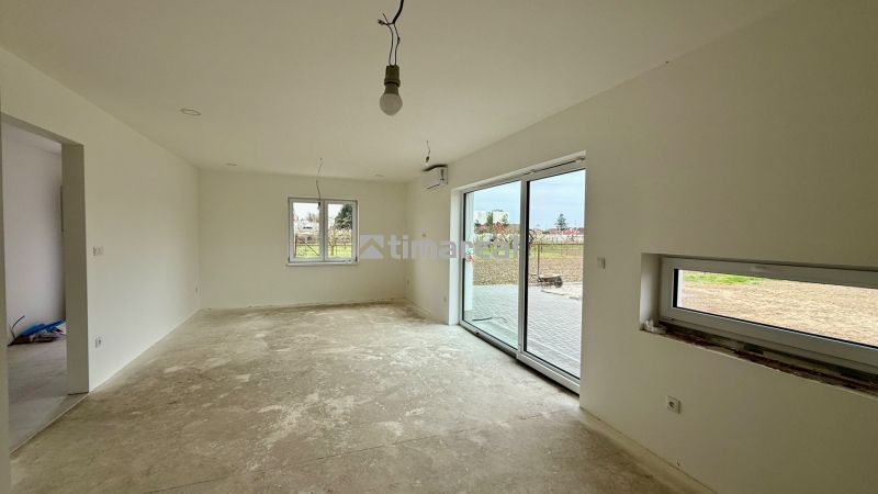 The family house has a spacious room with white walls and sliding doors.
