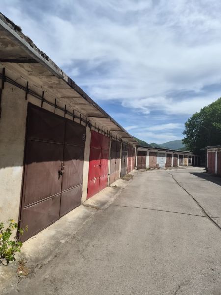 Garages on Štvrť SNP Street in Trenčianske Teplice under the blue sky.