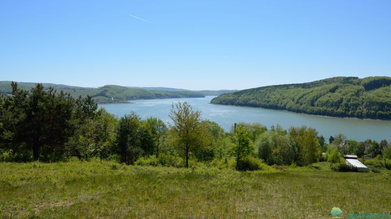 View from the recreational lands in Nová Kelča to the lake surrounded by forests.