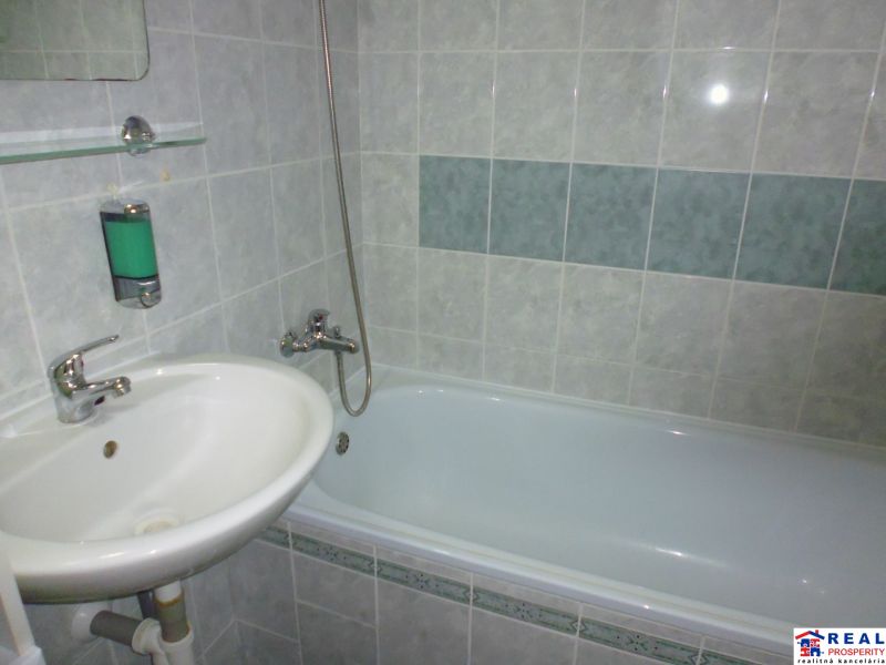 Bathroom in a 2-room apartment with a bathtub and a sink.