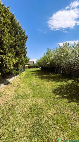 A garden surrounded by trees and a fence, Trebišov, South, suitable for residential plots.
