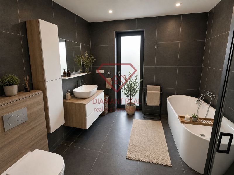 A bathroom in a family house with a bathtub, a sink, and dark tiles.