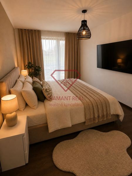 Bedroom in a family house with a bed, large TV, and floor with wooden decor.