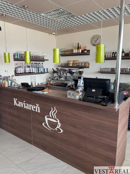 Interior of a café with wooden decor, counter, shelves, and a coffee machine, optimized for gastro spaces.
