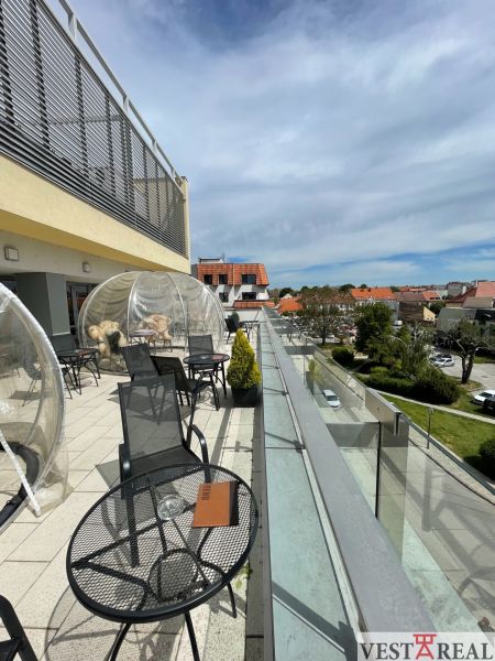 Terrace on Trojičné Square in Trnava with seating in gastro premises.
