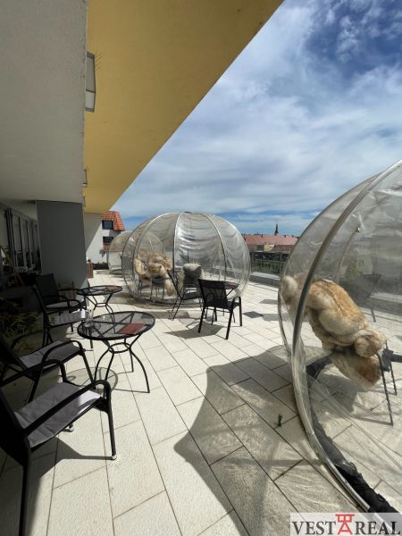 Terrace in Trnava on Trojičné Square with gastro spaces and transparent domes.