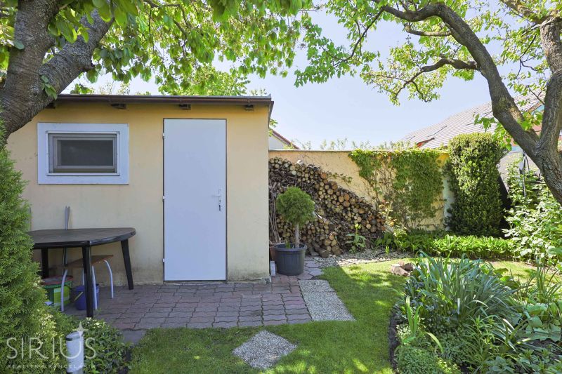 A garden at a family house on Hollého Street in Stupava, with a storage shelter.