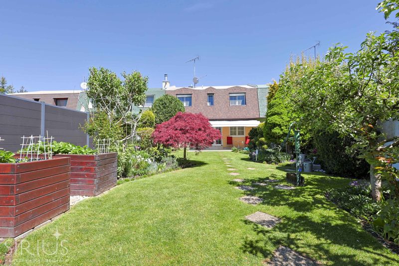A breathtaking garden of a family house in Stupava on Hollého Street full of greenery and flowers.