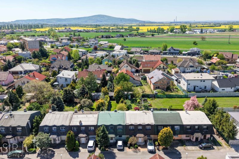 Aerial view of family houses in Stupava on Hollého Street with extensive surrounding countryside.