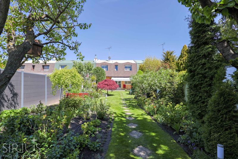 The garden of the family house on Hollého Street in Stupava, full of greenery and trees.