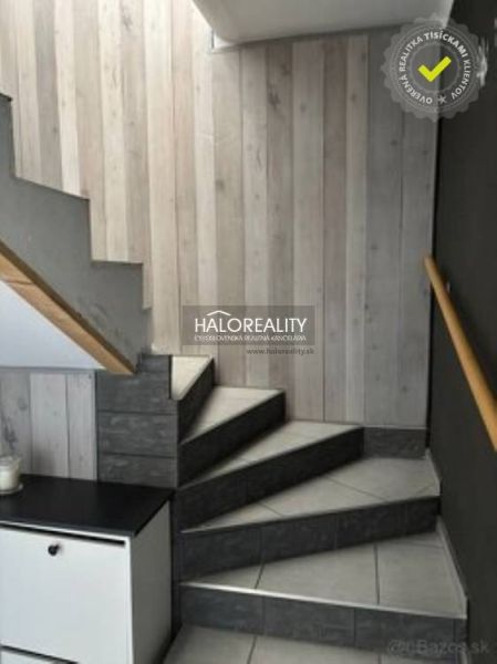 A staircase with wooden paneling and tiles in a family house.