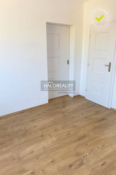 Interior of a family house with white doors and a floor with a wood decor.
