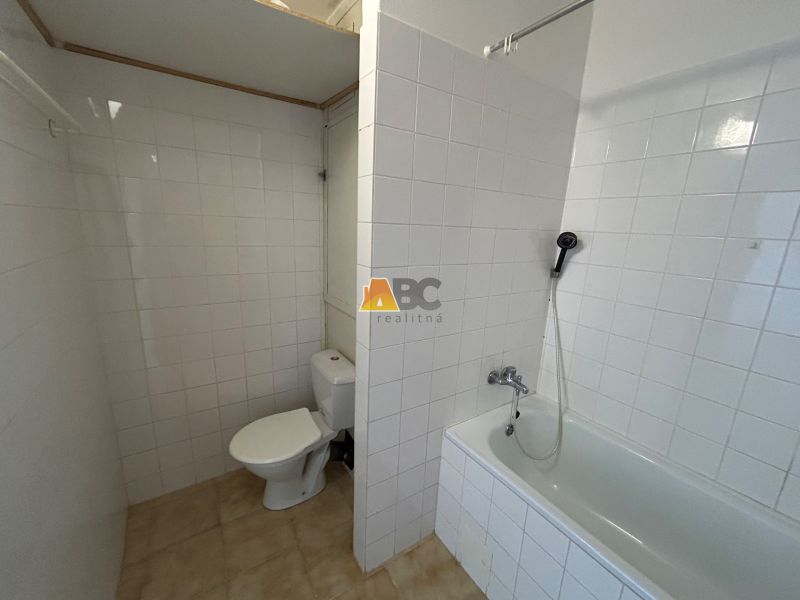 Bathroom in a 2-room apartment with a bathtub and toilet.