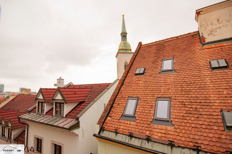 The church tower protruding above the roofs in Bratislava on Beblavého Street.