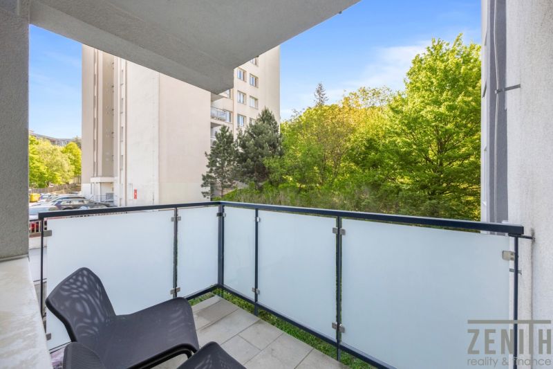 Balcony of a 2-room apartment in Bratislava - Old Town with a view of greenery and a building.