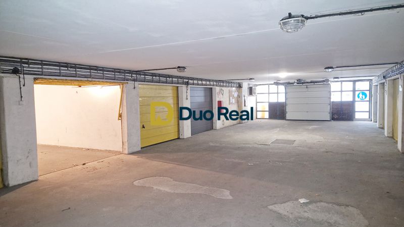 The interior of a garage with multiple doors, a well-lit and spacious area.