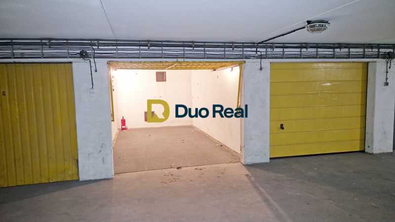 Garages on Majerníkova Street in Bratislava with open parking spaces and yellow doors.