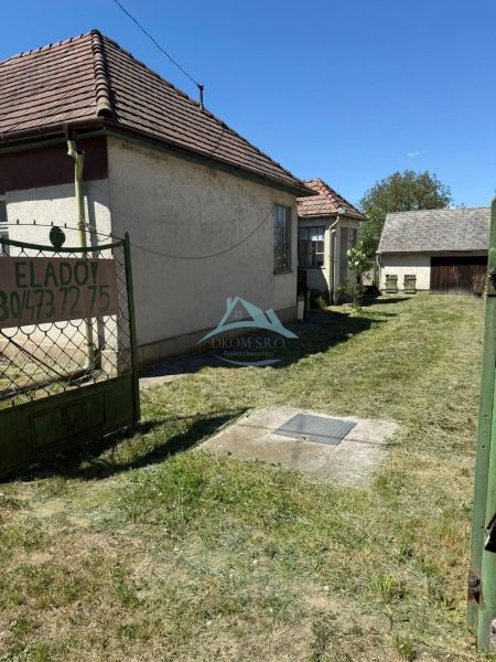 The family house in Hont has a landscaped yard with a lawn and access from the gate.