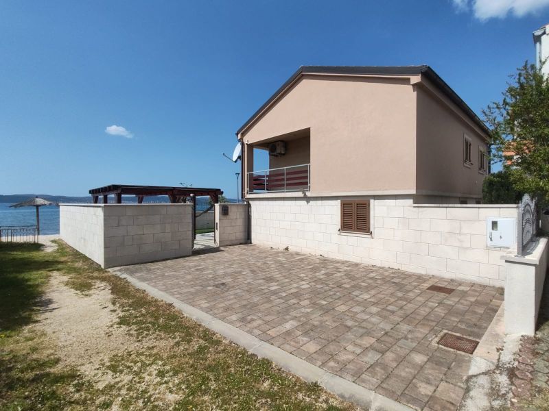 A family house in BIBINJE with a terrace by the sea and a paved courtyard.