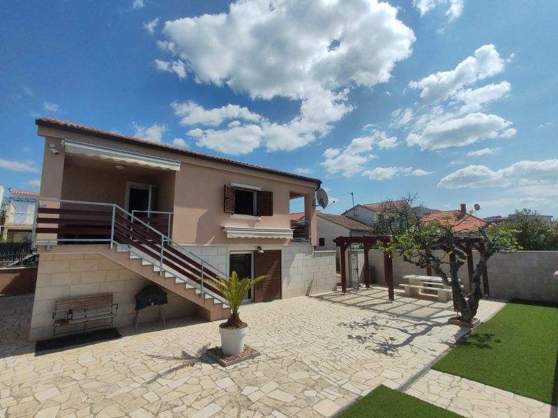 A family house in Bibinje with stairs, a terrace, and a gallery, surrounded by a garden.