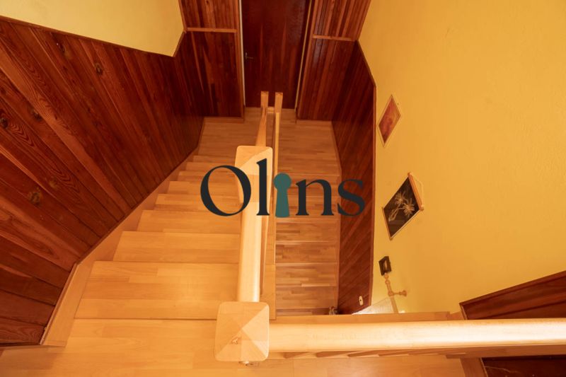 Staircase with wood decor flooring in a family house, walls paneled with wood.