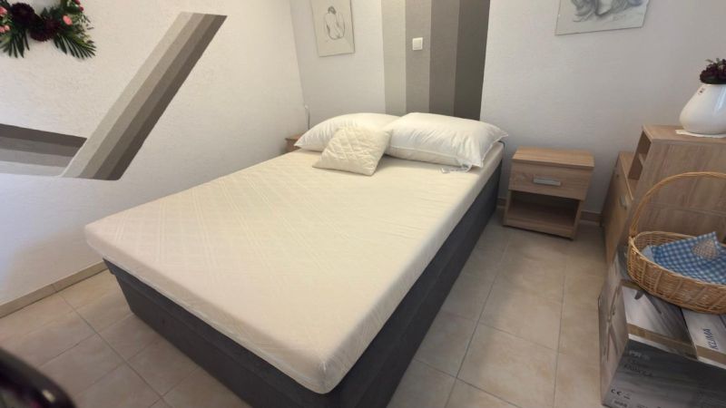 A bedroom in a family house with a single bed and nightstands.