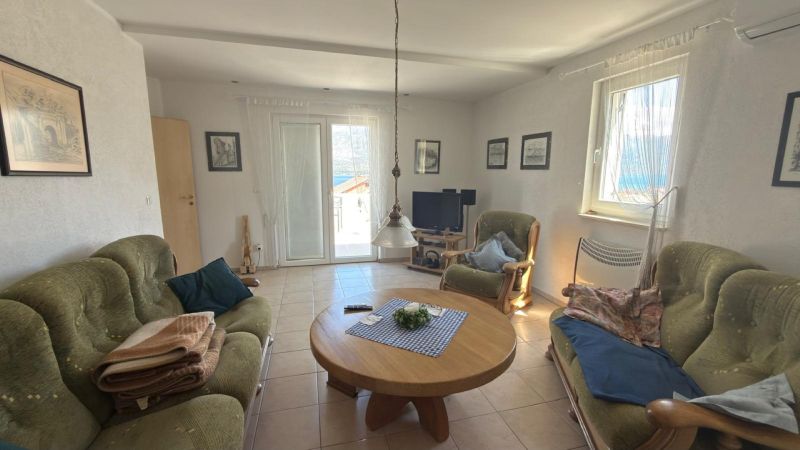 Living room in a family house with comfortable sofas and a wooden coffee table.