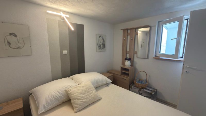Bedroom in a family house with decorative lighting and pictures on the walls.