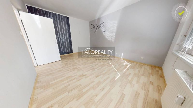 A bright room with a wood-decor floor, suitable for a studio apartment.
