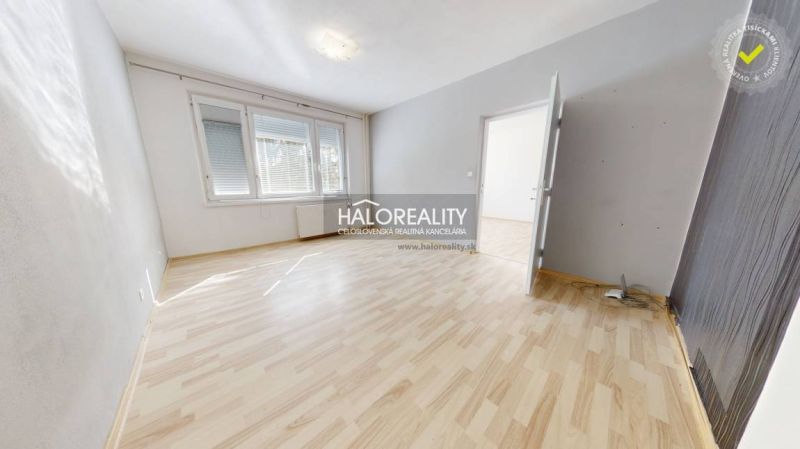 A bright room with a wooden decor floor in a studio apartment.