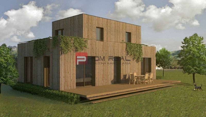 A two-story house with a terrace surrounded by greenery on a residential plot in Borinka.