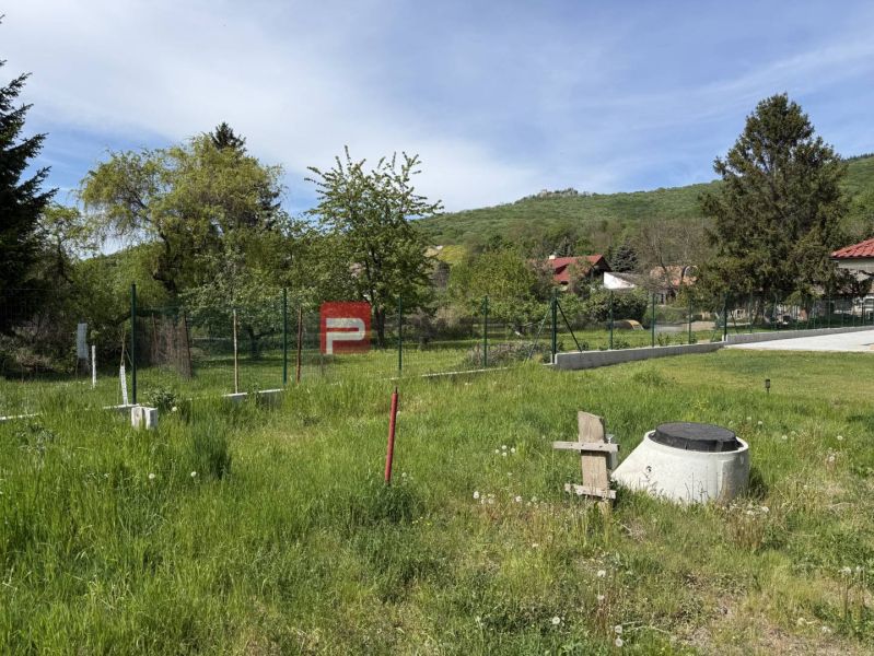 A grassy plot in Borinka, surrounded by trees, suitable for living.