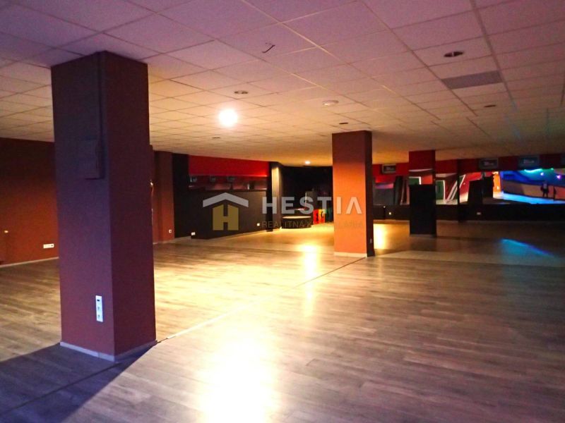 Large open space with wooden flooring, suitable for commercial purposes or offices.