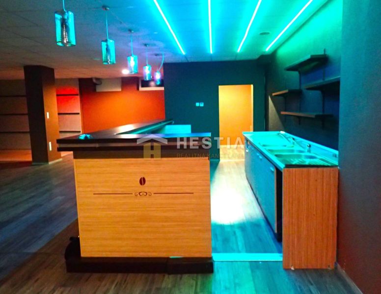 A bar counter with colorful lighting in commercial premises for rent.