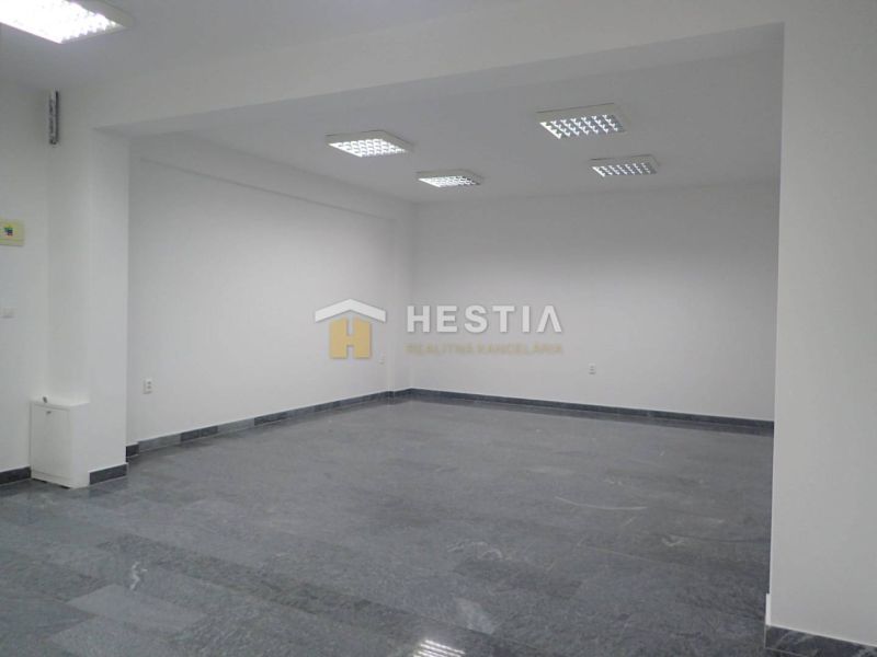 A spacious room with white walls and a stone-look floor in Land - commercial.