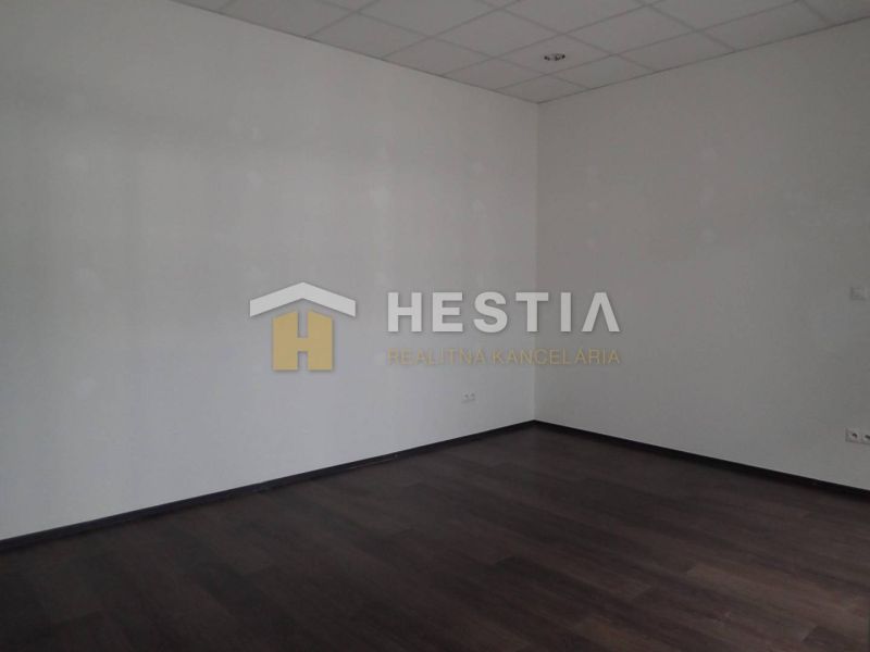 Empty room with a dark floor in a two-room apartment.